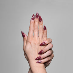 Hand model showing 3H Nails Luxury Handmade Press-on Nails in Latte Dots design on natural nails.