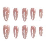 Ten almond-shaped press-on nails arranged in two rows of five on a plain white background. The nails have a glossy dusty pink base with small white polka dots.
