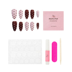 Nail art kit with nail extensions, alcohol pad, and other tools on a white background