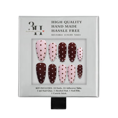 Set of press-on nails with polka dot design in pink and brown colors, displayed in a clear plastic case on a white background.