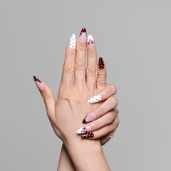 Hand model showcasing 3H Nails 3H Luxury Handmade Press-on Nails in Cherry Cola color on natural nails.
