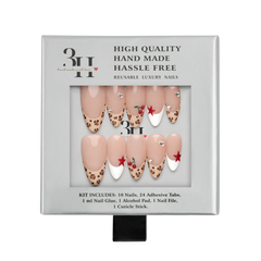 Atlanta medium almond press-on nails by 3H Nails, featuring a nude base with leopard-print tips, white French accents, red stars, cherries, and rhinestones, displayed in 3H Nails packaging.
