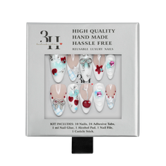 Chicago medium almond press-on nails by 3H Nails, featuring nude and white tones with blue accents, silver bows, stars, cherries, and rhinestones, displayed in 3H Nails packaging.