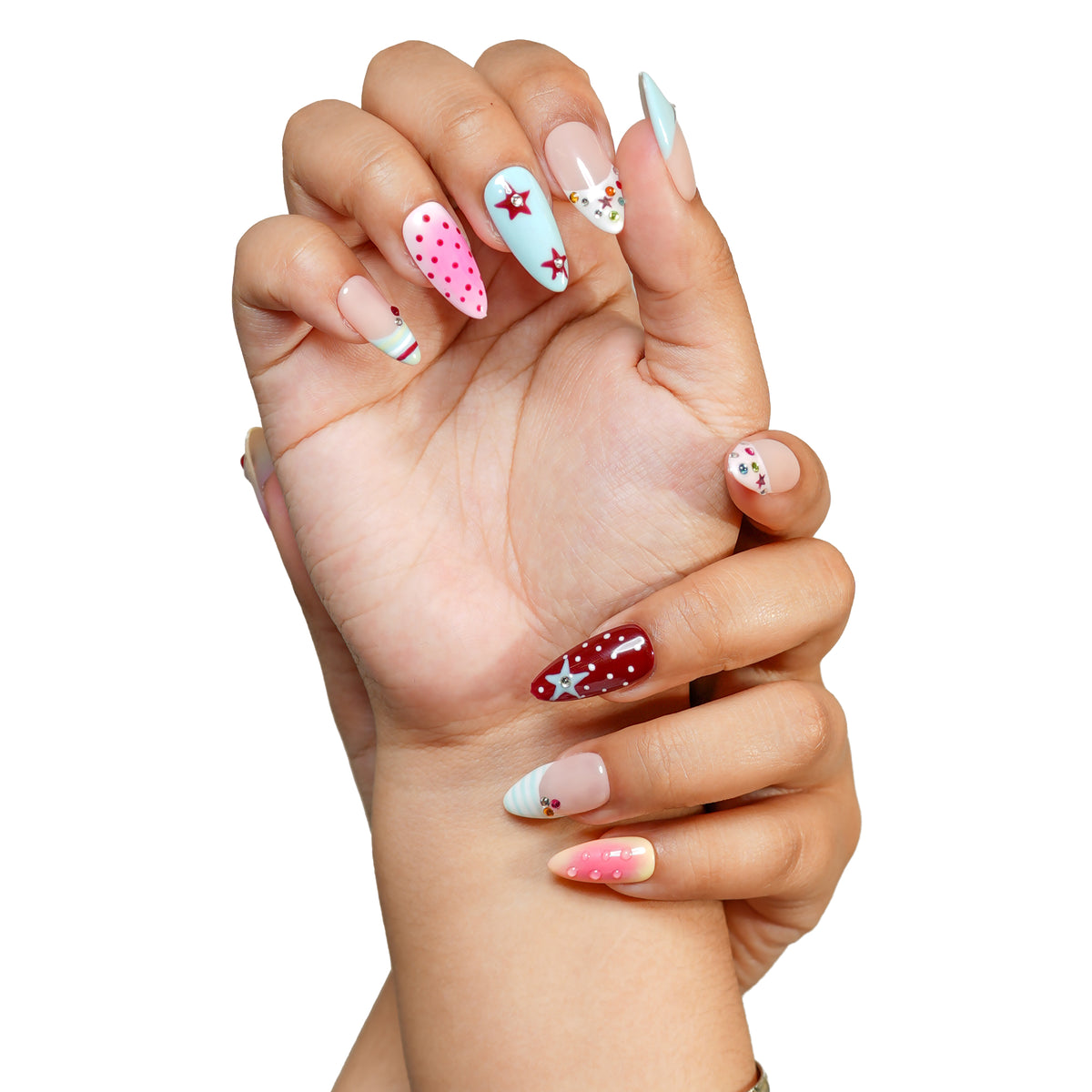 LA medium almond press-on nails by 3H Nails, featuring pastel blue, pink, burgundy, and nude designs with stars, polka dots, rhinestones, and ombre accents, shown on hands.