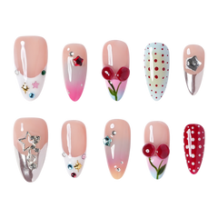 NYC medium almond press-on nails by 3H Nails, featuring mixed nude, red, pink, blue, and silver designs with cherries, polka dots, stars, and rhinestones.