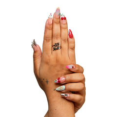 NYC medium almond press-on nails by 3H Nails, featuring mixed nude, red, pink, blue, and silver designs with cherries, polka dots, stars, and rhinestones, shown on hands.