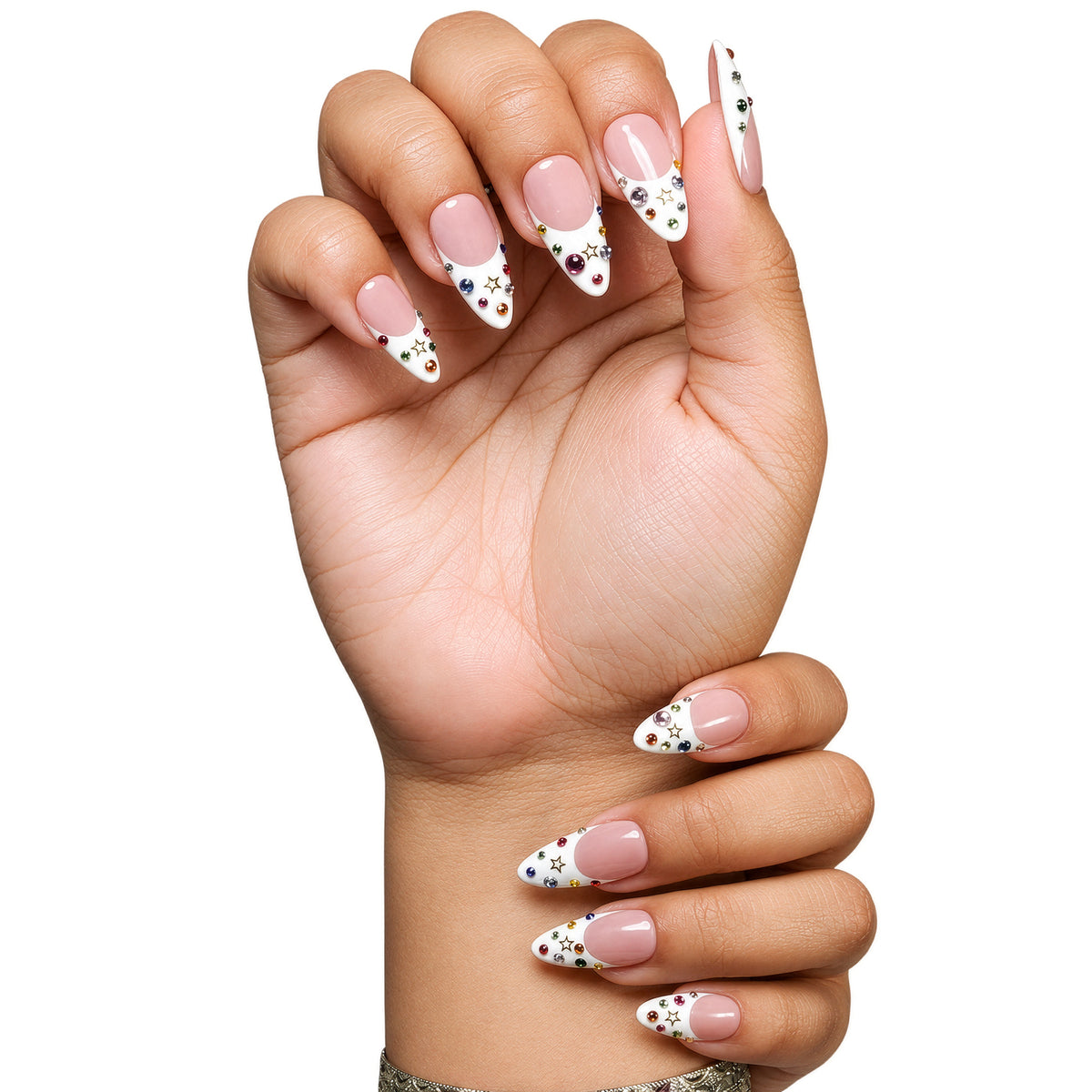 Dallas medium almond press-on nails by 3H Nails, featuring a nude base with white French tips, multicolor rhinestones, and gold star accents, shown in a lifestyle image.
