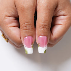 Close-up of Orchid Dreams long square press-on nails featuring raised green flowers, botanical accents and gold details.