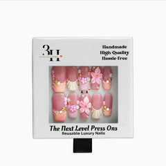 Set of long square press-on nails with rosy garden floral design by 3H Nails, showcasing delicate pink and green accents.