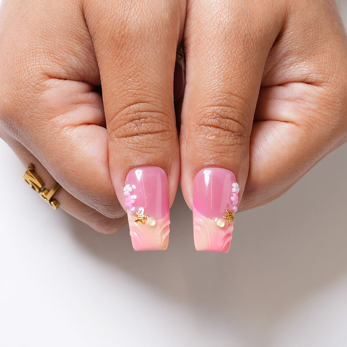 Long square press-on nails with a rosy garden floral design by 3H Nails, showcasing a delicate pink and green pattern.